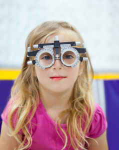 Girl getting her eyes examined by Lapel Eye Doctors Dr. Amy Walden